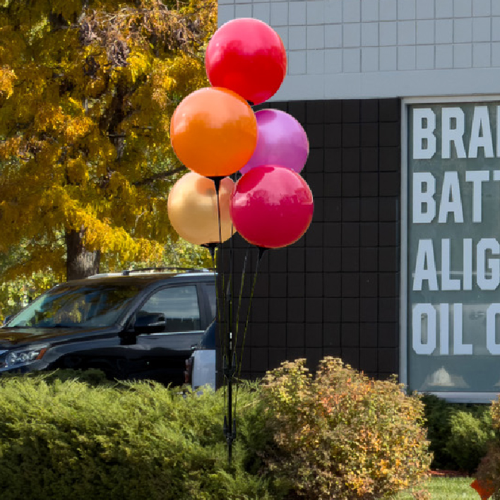 Reusable Balloon Clusters Reusable Vinyl Balloon Clusters in Fall colors at automotive dealership.